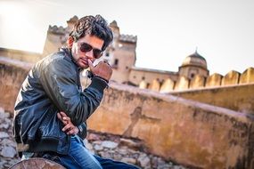 young man near the palace, india, rajasthan