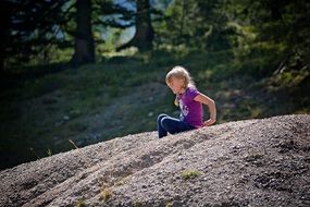 little girl on a sandy hill