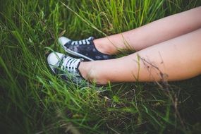 girl in sneakers on a meadow