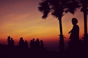 silhouettes of people at sunset