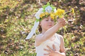 portrait of child girl with flowers in hand
