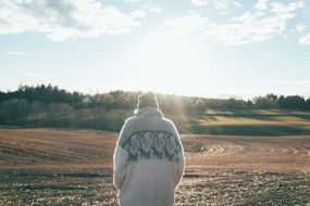 Girl in a sweater on the field