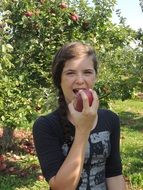 girl eating picked apple