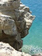 rock over blue water