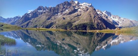 Landscape of alps on a lake bank