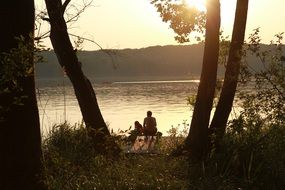 man with child rest at lake