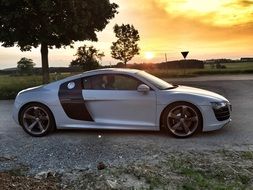 landscape of sports car on nature at the sunset
