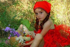 girl in the red dress in the forest