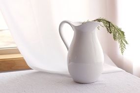 twig in a white jug as a still life