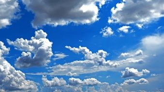 white clouds in the sunny sky