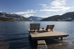 benches overlooking the mountain landscape on a lake in Seeboden, Austria