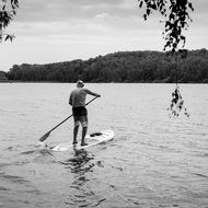 Black and white photo of old man is surfing