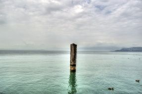 Wooden column in sea water landscape