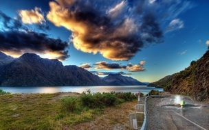 road near the lake and mountains