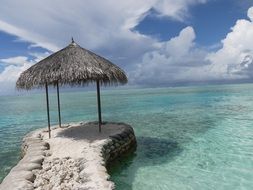 Tropical beach on a cloudy sky background