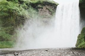 splashes of waterfall on the background of the rock