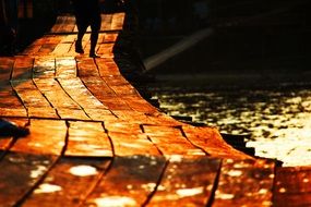 golden walking path on pier at sunset