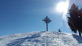 Cross on top of the alpine mountains