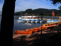 flat rows of boats near the pier on Lake Titisee