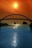 sun over arched bridge