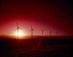 red sunset with windmills