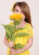 long haired caucasian little girl with sunflower