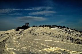 snowy landscape in the mountains under a blue sky