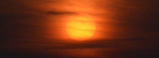 Sun at sunset in a light haze