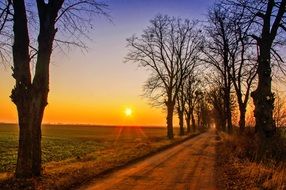 landscape of sun rays over a rural field in Poland