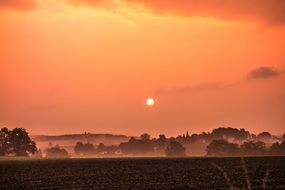 landscape of a village at red sunset