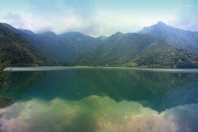 beautiful mirror mountain lake in Italy
