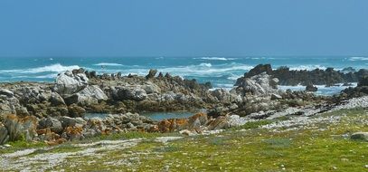 wild rocky coast at blue sea