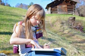 little girl with blond long hair reading