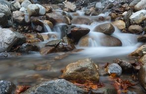 Beautiful creek wave on colorful stones