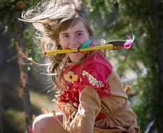 child girl plays in Indian costume