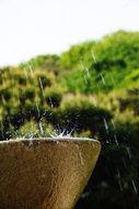 closeup photo of water drops from stone fountain