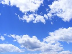 blue day sky with fluffy clouds