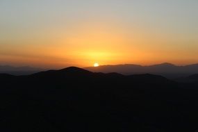 distant view of the orange sun at sunset