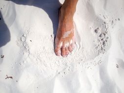 foot on white sand