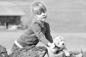 nice girl playing with teddy bear