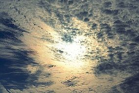 sun on the background of cumulus clouds