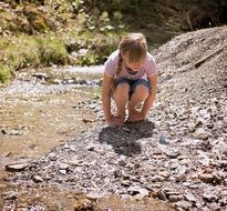 barefoot child near a small pond