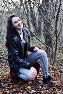 the girl laughs in the autumn forest
