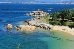 distant view of the lighthouse on the island of illa de arousa