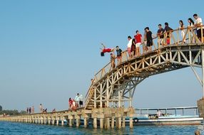 jumping from the bridge into the water on a sunny day