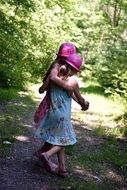 children go hugging near green bushes