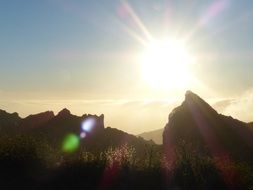 bright yellow sun over the mountains