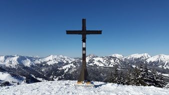 landscape of cross on mount rangiswanger horn in bavaria