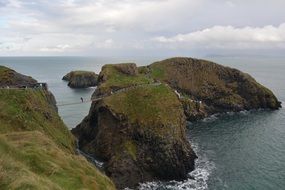 rope bridge between rocks sea view, northern ireland