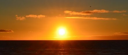 Huge sun at sunset on the ocean